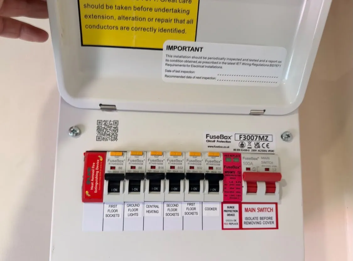 Upgraded consumer unit with labelled breakers and safety notices