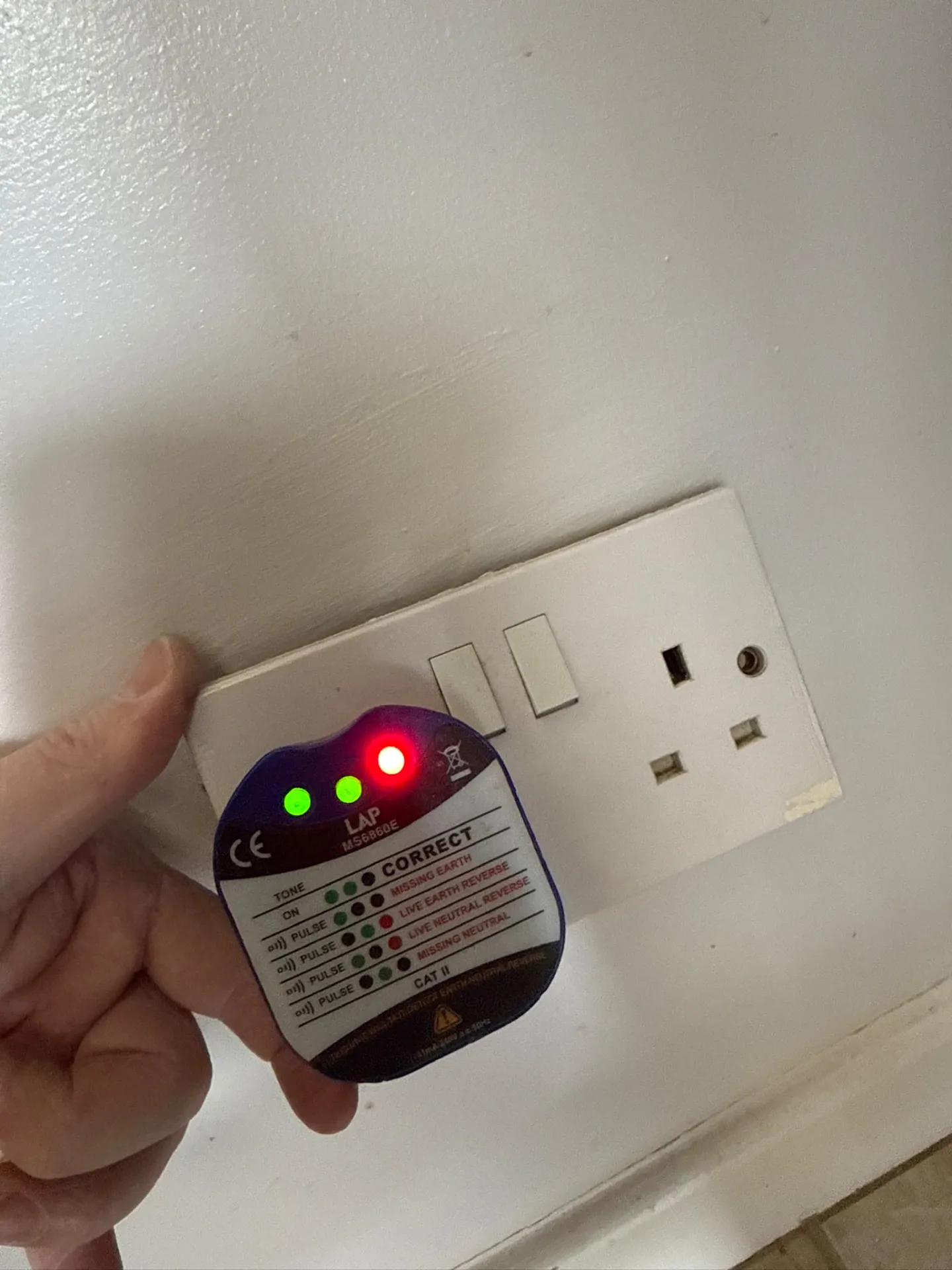 Socket tester checking a wall socket
