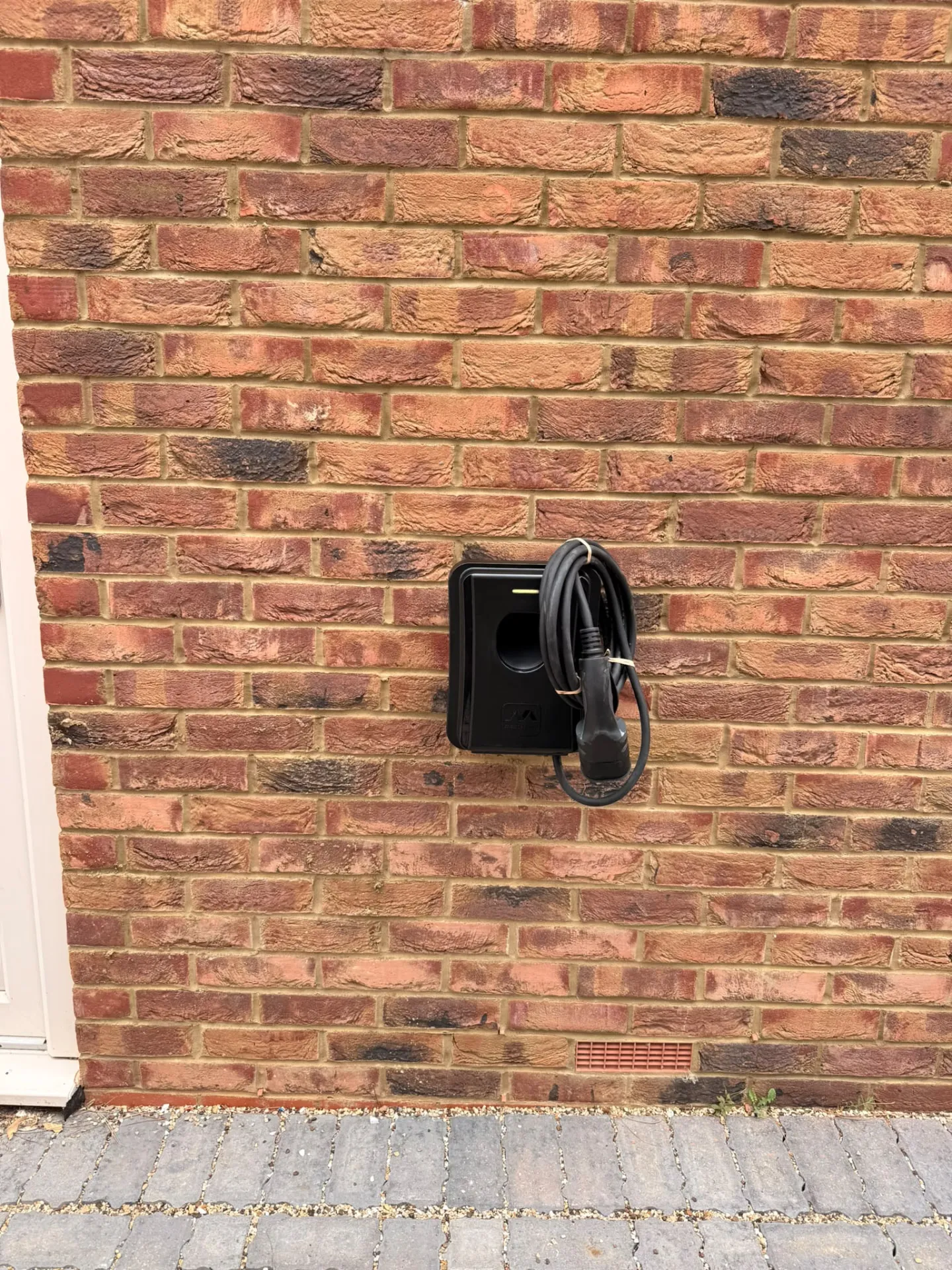 Wall-mounted home EV charger with cable