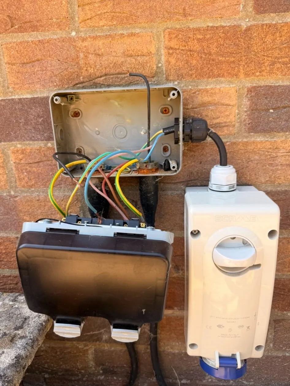 Outdoor power supply being wired with weatherproof socket