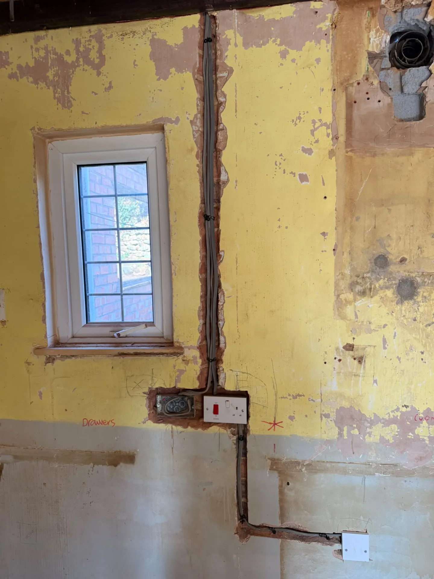 Rewire cable routes chased into plaster ready for new sockets