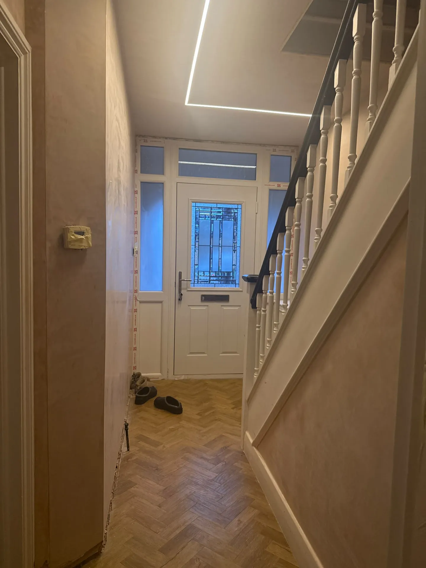 Hallway with recessed linear LED ceiling lighting installed