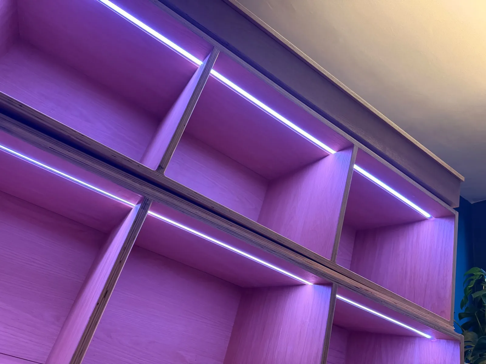 Built-in shelving with purple LED strip lighting